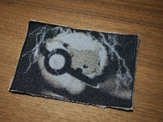 Pikachu jumping out of a Pokéball as an embroidered patch with color accents, 13x9 cm